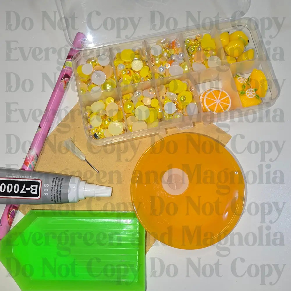 Rhinestone kit with wax pencil, glue-acrylic lid, tray, sandpaper, and charms