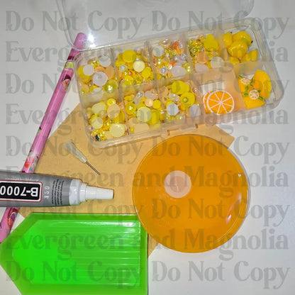 Rhinestone kit with wax pencil, glue-acrylic lid, tray, sandpaper, and charms
