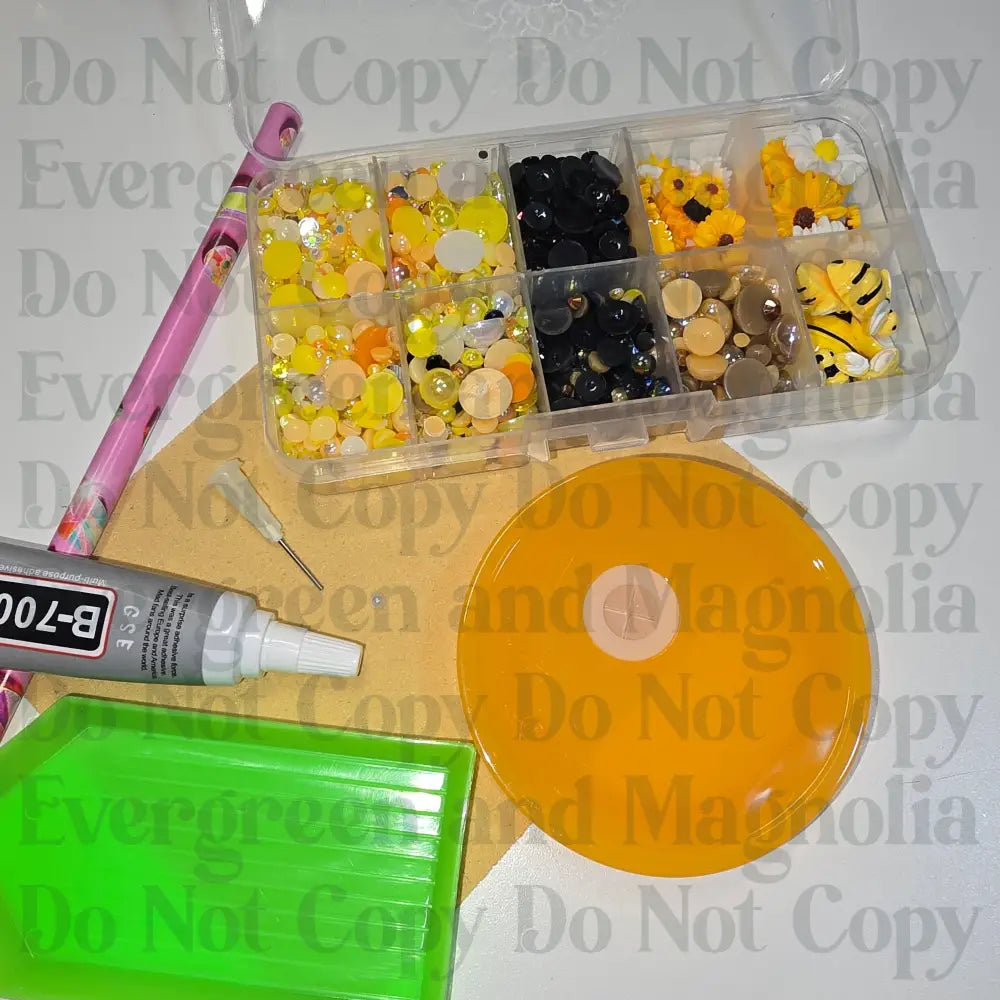 Rhinestone kit with wax pencil, glue-acrylic lid, tray, sandpaper, and charms
