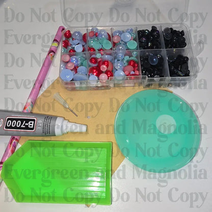 Rhinestone kit with wax pencil, glue-acrylic lid, tray, sandpaper, and charms