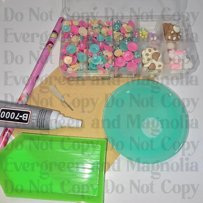 Rhinestone kit with wax pencil, glue-acrylic lid, tray, sandpaper, and charms