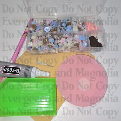 Rhinestone kit with wax pencil, glue-acrylic lid, tray, sandpaper, and charms
