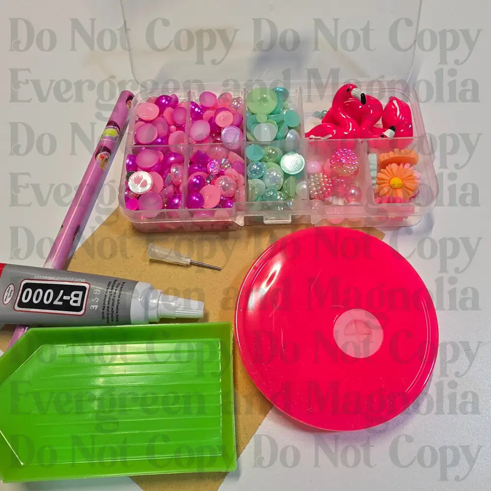 Rhinestone kit with wax pencil, glue-acrylic lid, tray, sandpaper, and charms