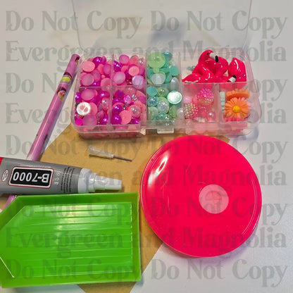 Rhinestone kit with wax pencil, glue-acrylic lid, tray, sandpaper, and charms