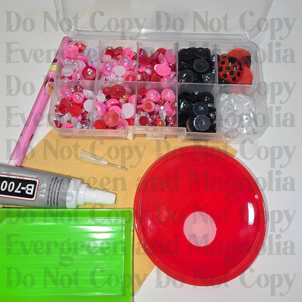 Rhinestone kit with wax pencil, glue-acrylic lid, tray, sandpaper, and charms