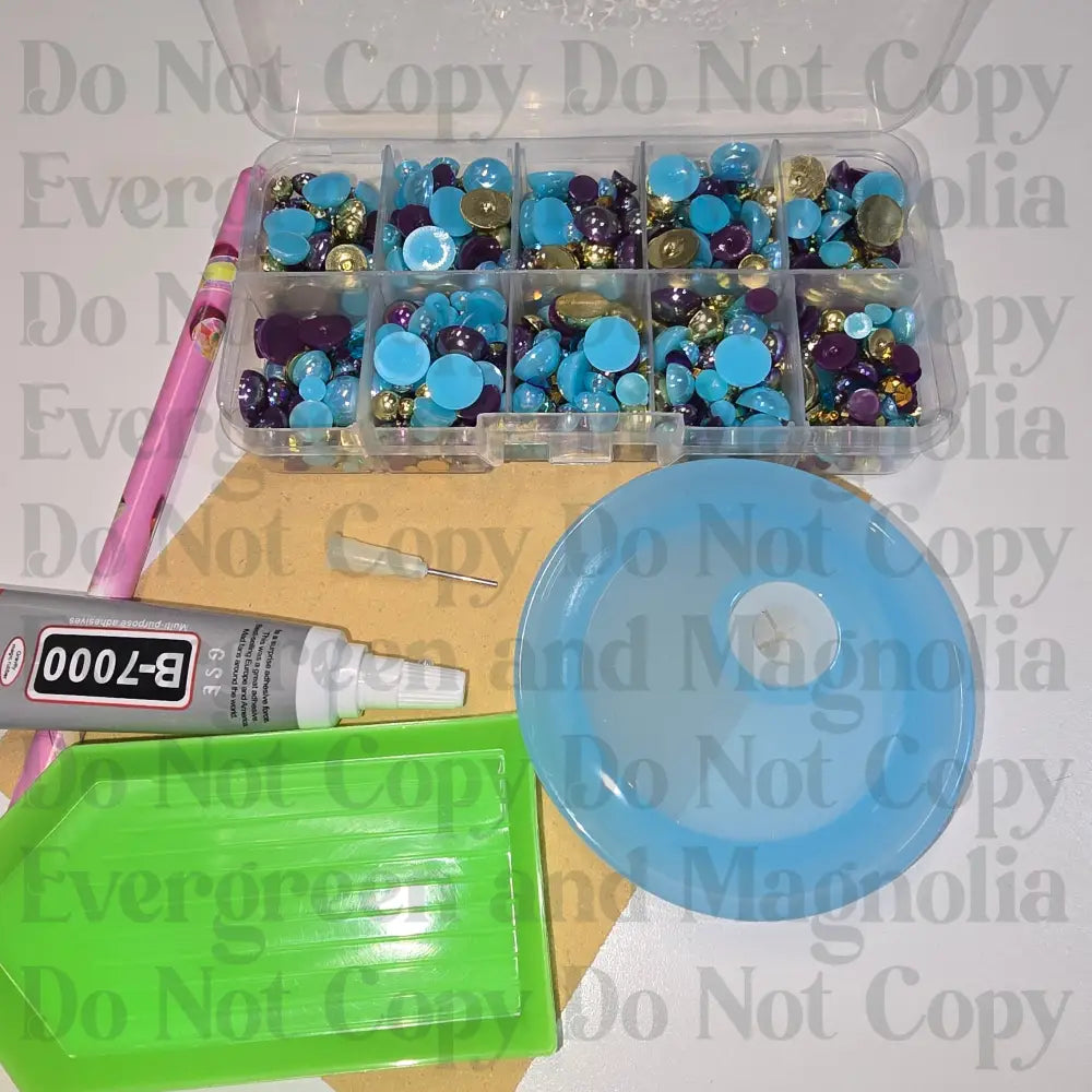 Rhinestone kit with wax pencil, glue-acrylic lid, tray, sandpaper, and charms