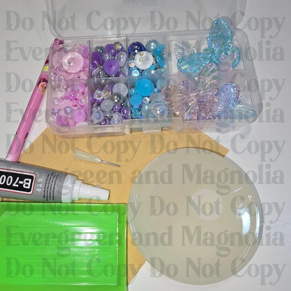 Rhinestone kit with wax pencil, glue-acrylic lid, tray, sandpaper, and charms