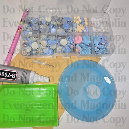 Rhinestone kit with wax pencil, glue-acrylic lid, tray, sandpaper, and charms