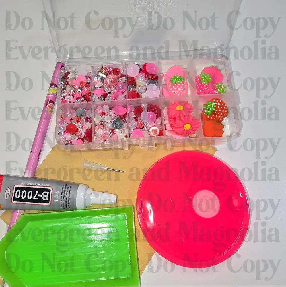 Rhinestone kit with wax pencil, glue-acrylic lid, tray, sandpaper, and charms