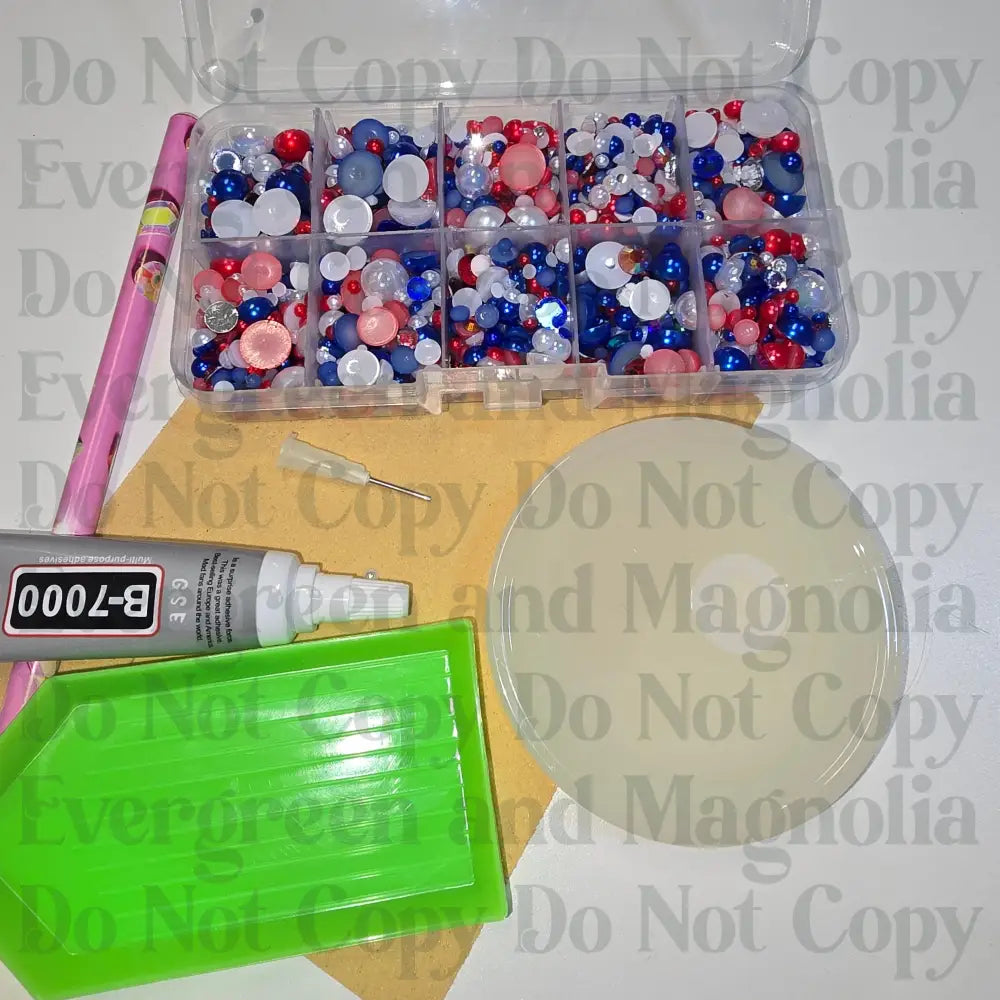Rhinestone kit with wax pencil, glue-acrylic lid, tray, sandpaper, and charms