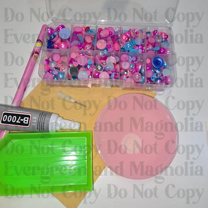 Rhinestone kit with wax pencil, glue-acrylic lid, tray, sandpaper, and charms