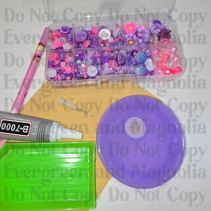 Rhinestone kit with wax pencil, glue-acrylic lid, tray, sandpaper, and charms