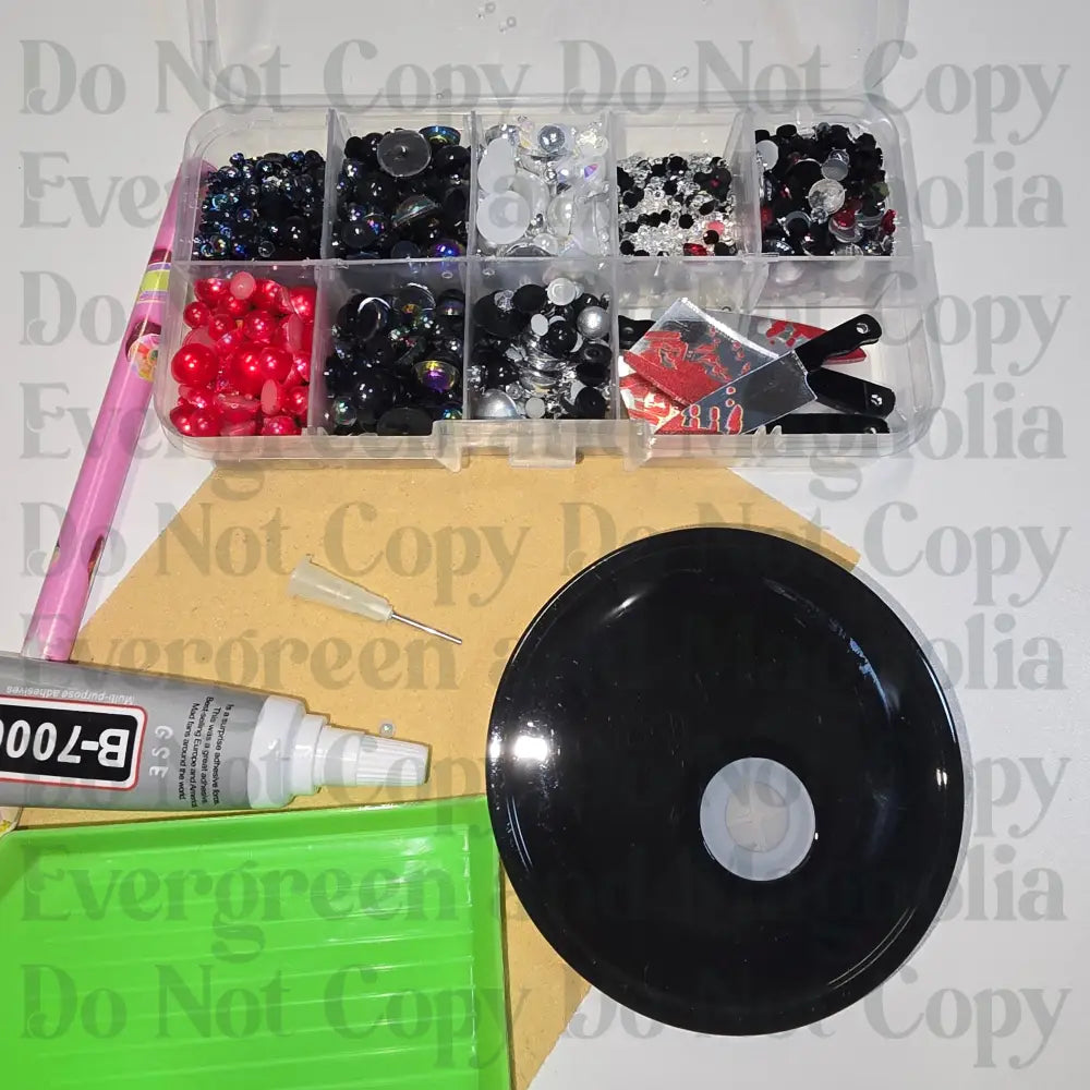 Rhinestone kit with wax pencil, glue-acrylic lid, tray, sandpaper, and charms