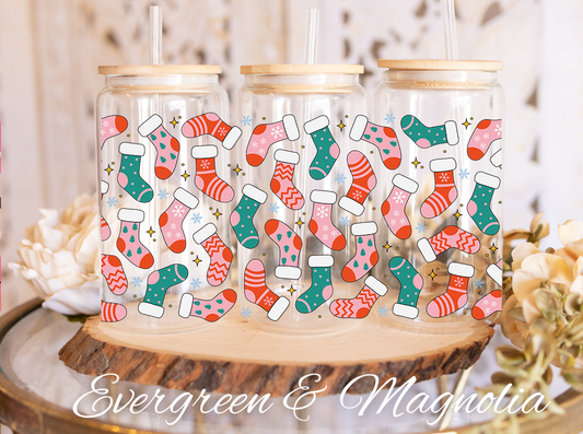 a set of three glass jars with christmas stockings and stockings on them