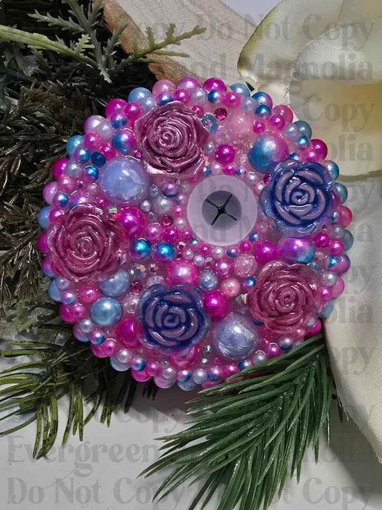 Decorative lid with pink and blue roses on a floral background